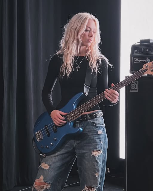 Aiva playing bass guitar